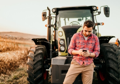Lengericher Versicherungen - Mann lehnt an Traktor